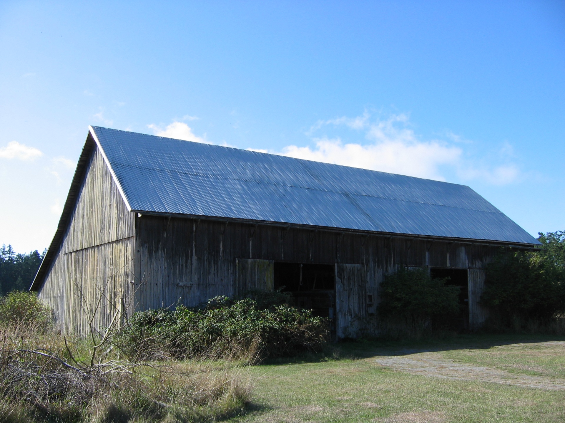The Edson Weeks barn, a large weathered timber-frame barn with a broken gable roof